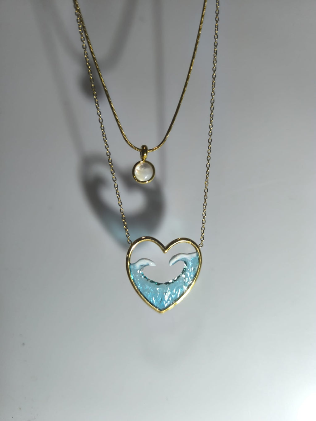 Collar con colgante en forma de corazón y olas